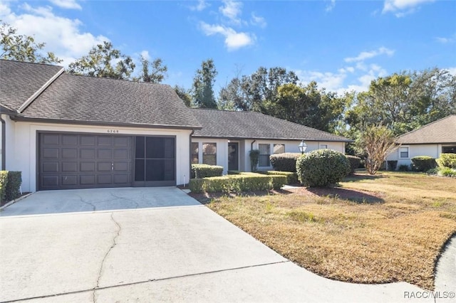 view of front of home with a garage and a front lawn