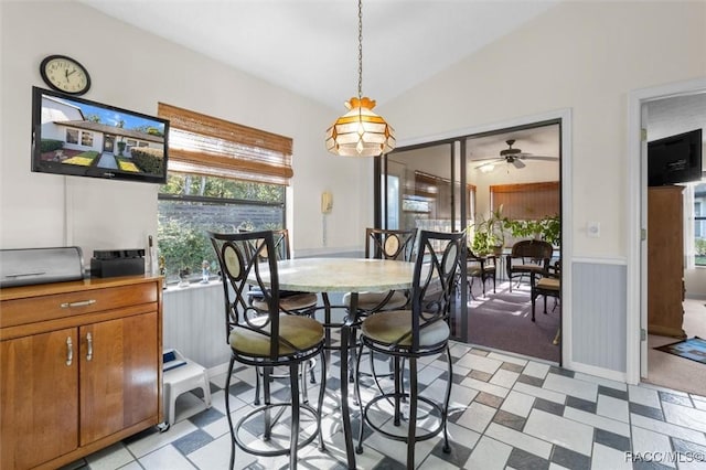 dining space featuring ceiling fan and vaulted ceiling