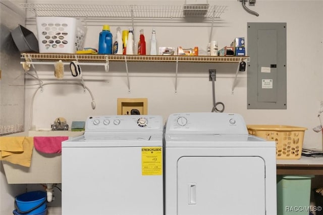 laundry room with electric panel, washer and clothes dryer, and sink