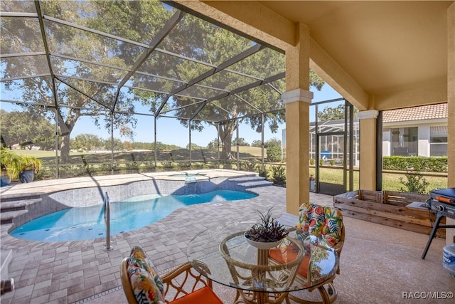 view of pool featuring a hot tub, a patio, and glass enclosure