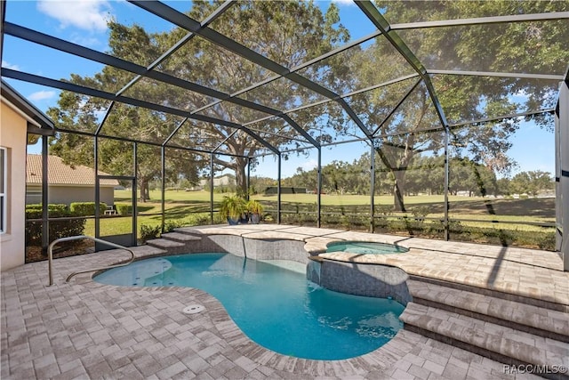 view of swimming pool featuring a lanai, a patio area, and an in ground hot tub