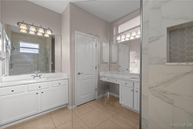 full bath featuring walk in shower, two vanities, a sink, and tile patterned flooring