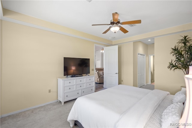 carpeted bedroom featuring ceiling fan and a closet