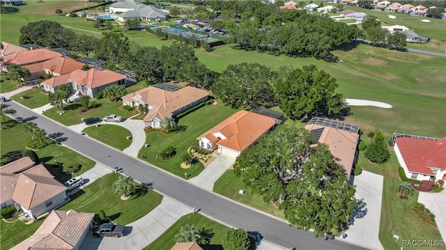 drone / aerial view with golf course view and a residential view