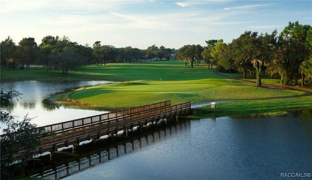 view of property's community featuring a water view, golf course view, and a lawn