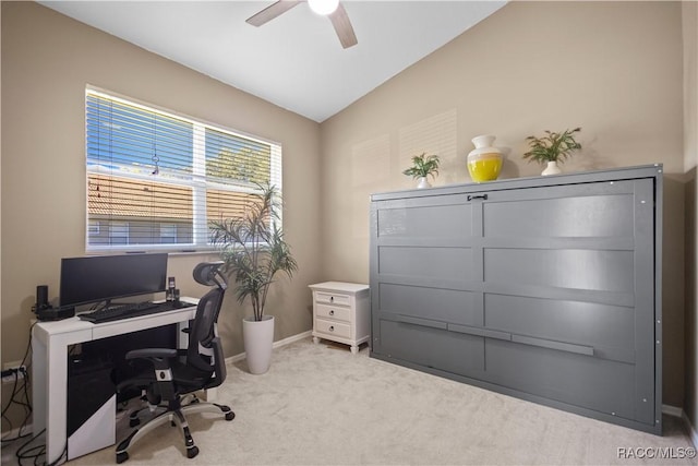 carpeted office with vaulted ceiling, ceiling fan, and baseboards