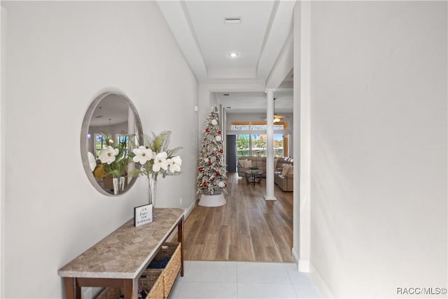 interior space featuring light tile patterned flooring, recessed lighting, visible vents, baseboards, and ornate columns