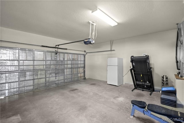 garage with a garage door opener and freestanding refrigerator