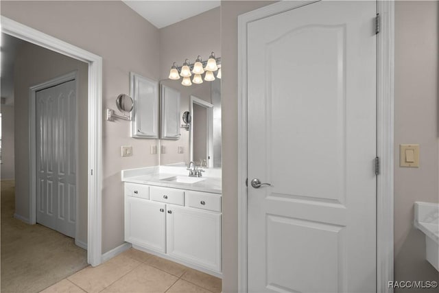 bathroom with vanity, baseboards, and tile patterned floors