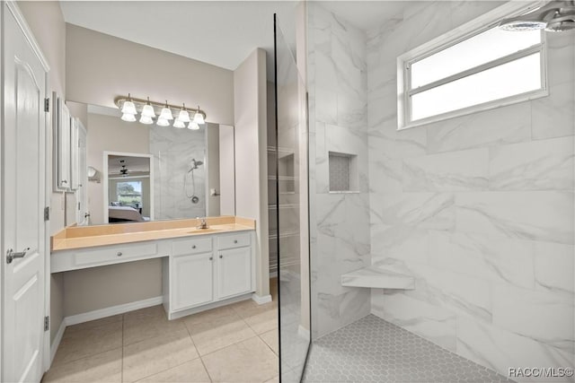 bathroom with vanity and tiled shower