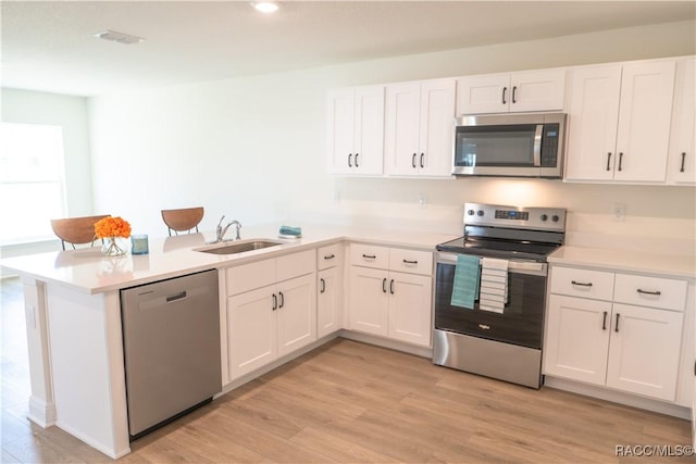 kitchen featuring white cabinetry, appliances with stainless steel finishes, and sink