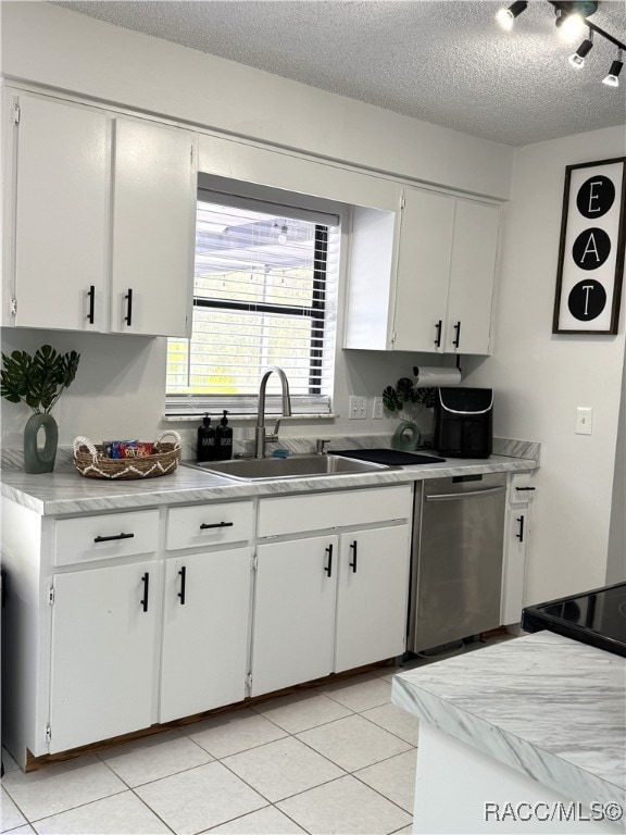 kitchen featuring stainless steel dishwasher, sink, white cabinetry, and a textured ceiling