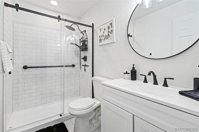 bathroom featuring tile patterned floors, vanity, toilet, and an enclosed shower