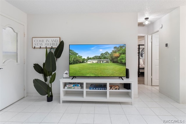 living room with light tile patterned flooring and a textured ceiling