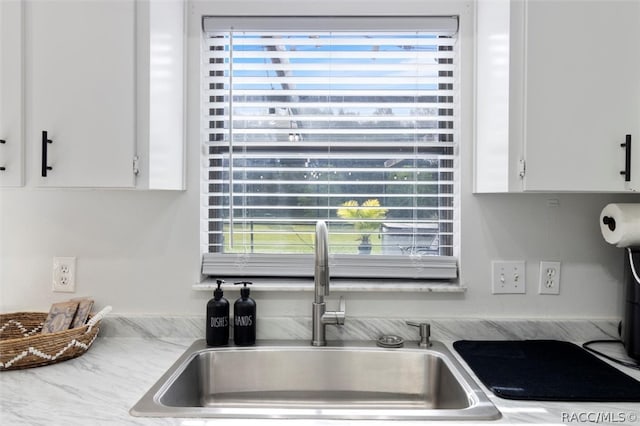 kitchen with white cabinetry and sink