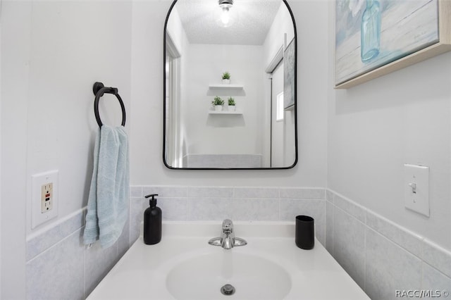 bathroom with sink and a textured ceiling