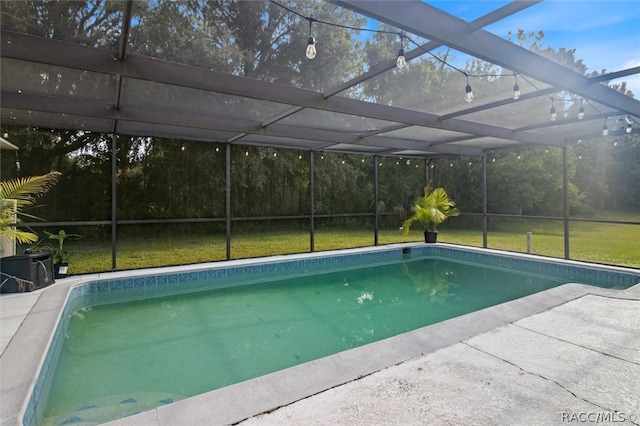 view of swimming pool featuring a lanai and a yard