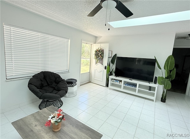 tiled living room featuring lofted ceiling, ceiling fan, and a textured ceiling