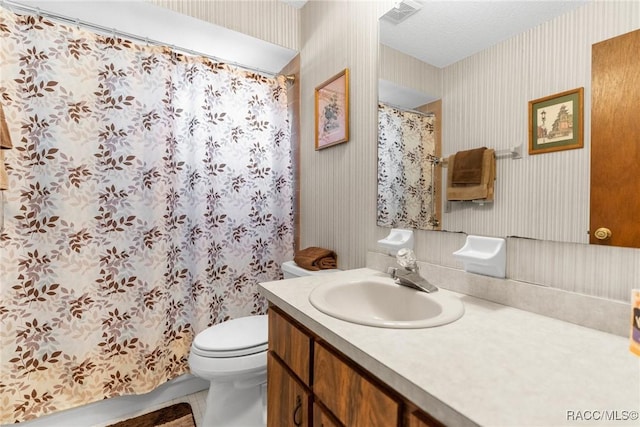bathroom with visible vents, vanity, curtained shower, toilet, and wallpapered walls