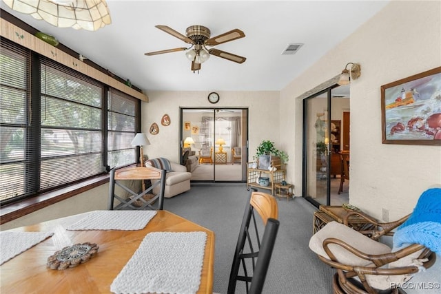 interior space with a ceiling fan and visible vents