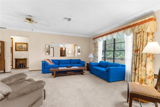 living room with ornamental molding, carpet, a ceiling fan, and visible vents