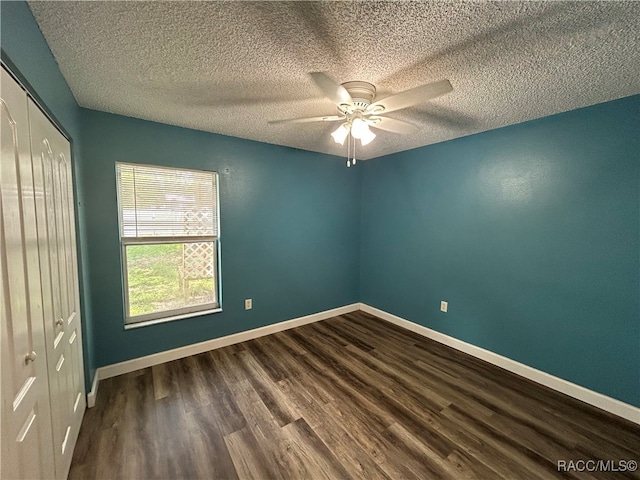 empty room featuring ceiling fan, hardwood / wood-style floors, and a textured ceiling