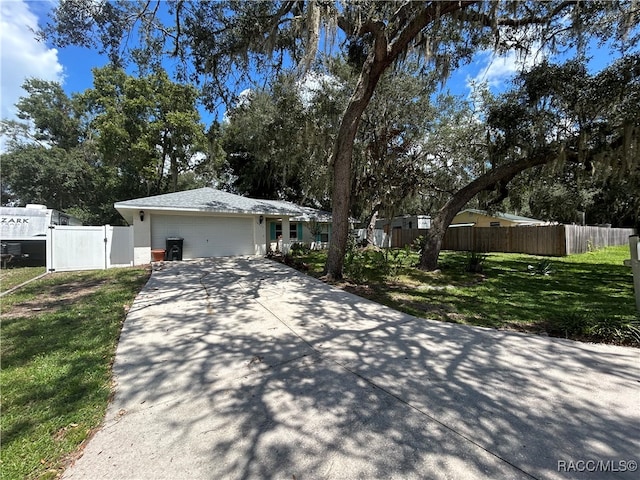 ranch-style home featuring a front yard and a garage