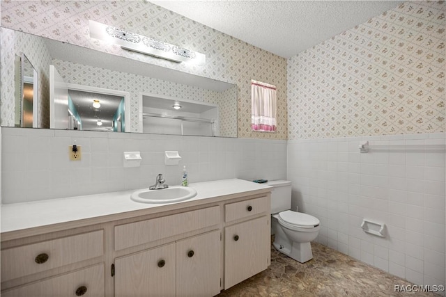 522 Hiawatha Ave, Inverness, FL 34452 - bathroom featuring wallpapered walls, toilet, a wainscoted wall, vanity, and tile walls