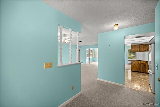 522 Hiawatha Ave, Inverness, FL 34452 - corridor with baseboards, a textured ceiling, and carpet flooring