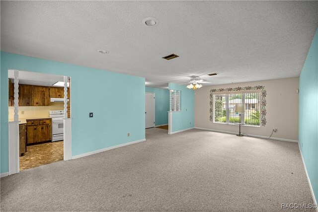 522 Hiawatha Ave, Inverness, FL 34452 - unfurnished living room with a textured ceiling, ceiling fan, light carpet, and baseboards
