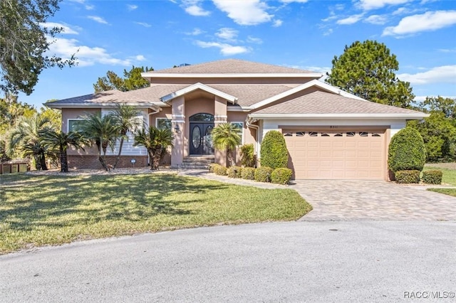 view of front of property with a garage and a front yard