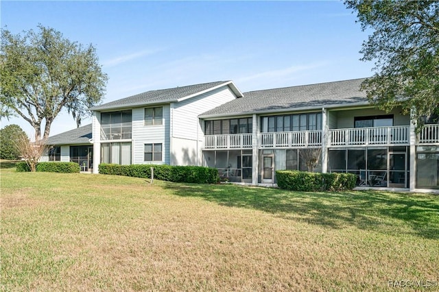 rear view of property with a yard