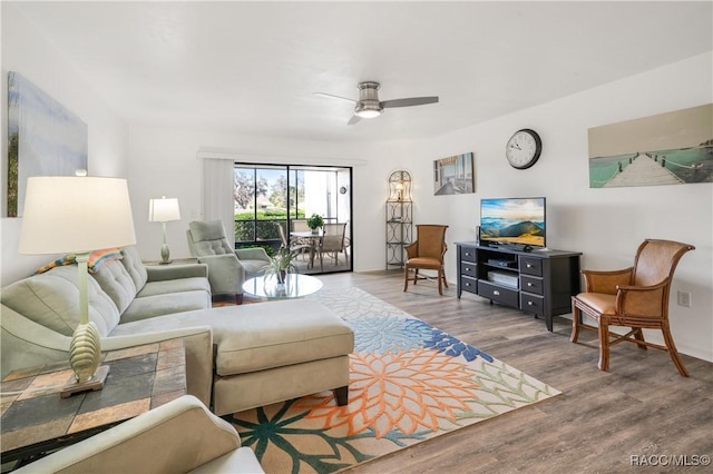 living room with ceiling fan and hardwood / wood-style flooring