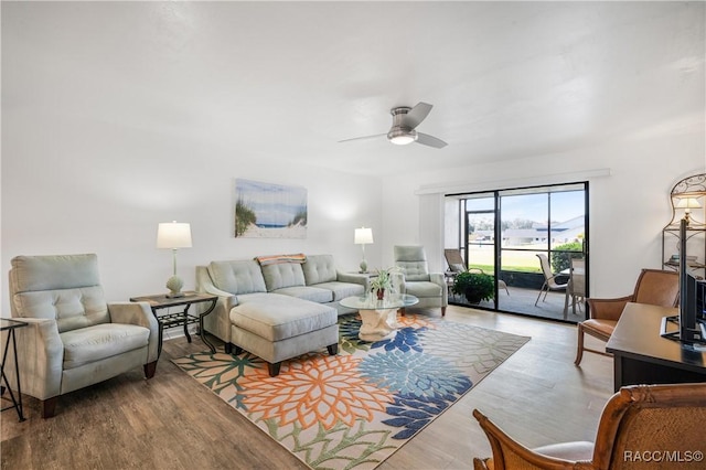 living room with ceiling fan and hardwood / wood-style floors