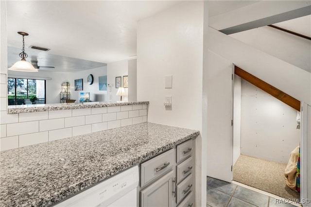 interior space featuring ceiling fan, light stone counters, white dishwasher, light colored carpet, and pendant lighting