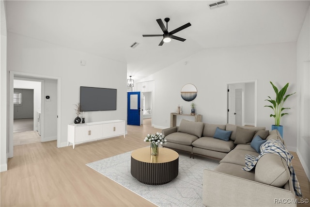 living room with ceiling fan, light hardwood / wood-style floors, and lofted ceiling