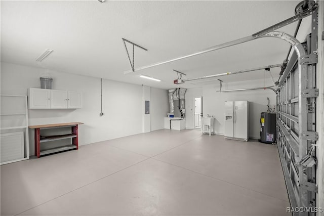 garage featuring white fridge with ice dispenser, sink, water heater, heating unit, and a garage door opener