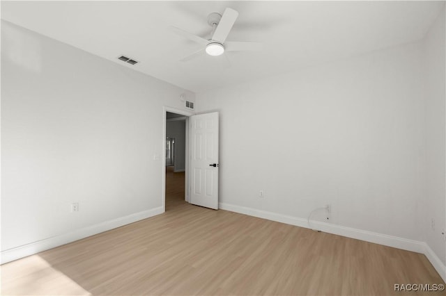 empty room with light wood-type flooring and ceiling fan