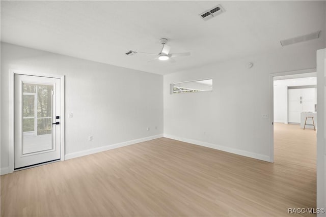 empty room with light hardwood / wood-style flooring and ceiling fan