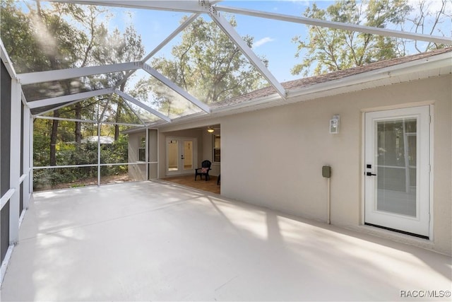 unfurnished sunroom featuring vaulted ceiling and a healthy amount of sunlight