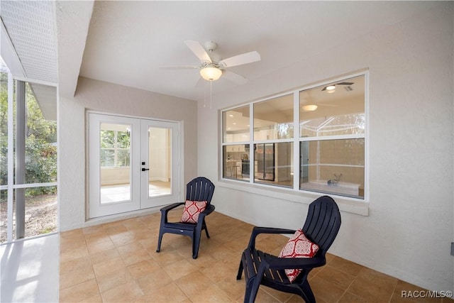 sunroom featuring french doors and ceiling fan