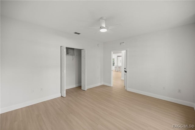 unfurnished bedroom with a closet, ceiling fan, and light hardwood / wood-style flooring