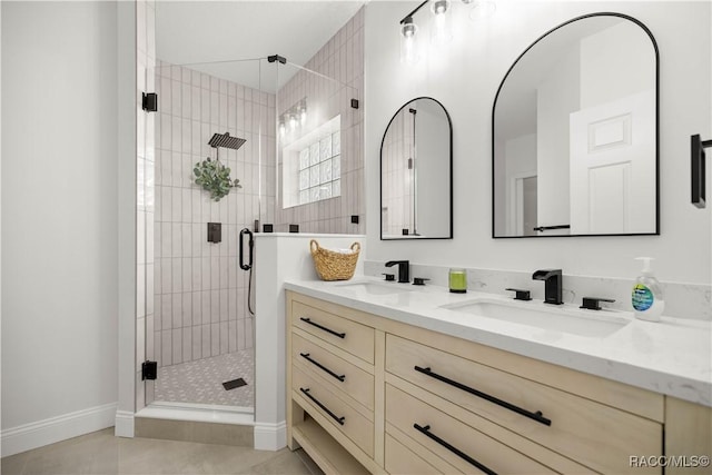 bathroom with tile patterned flooring, vanity, and a shower with door