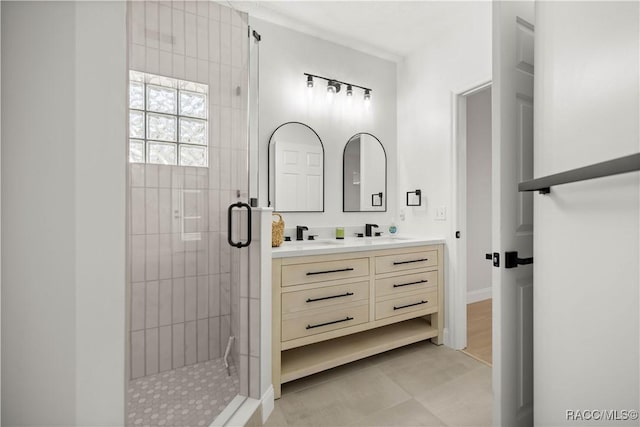 bathroom with tile patterned flooring, vanity, and an enclosed shower