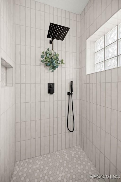 bathroom with a tile shower