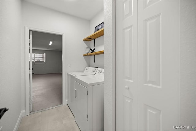 clothes washing area with washer and clothes dryer