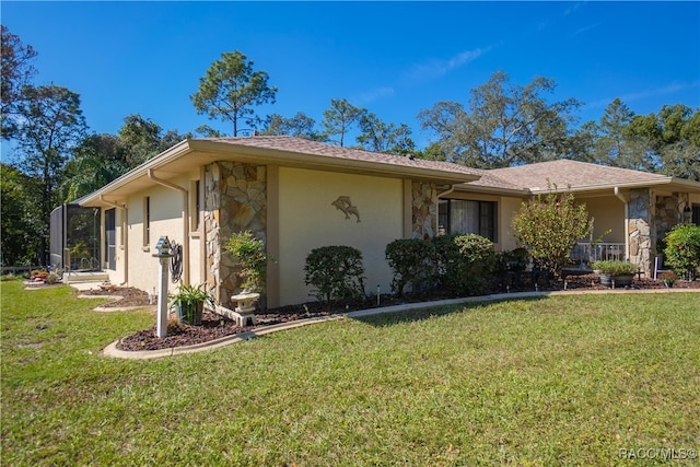 view of front of property featuring a front lawn and a lanai