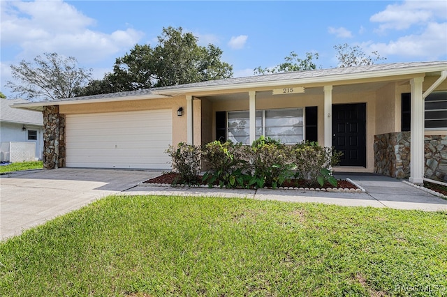 ranch-style house featuring a garage and a front lawn