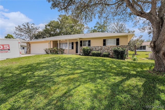 ranch-style house featuring a garage, a front yard, and central AC