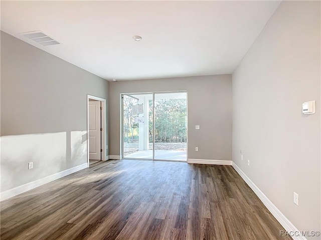 spare room with dark hardwood / wood-style flooring